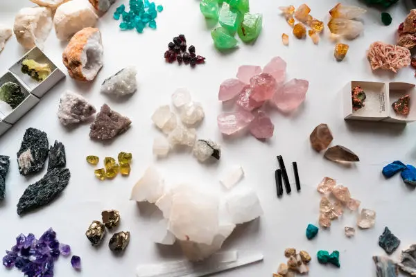 Collection of beautiful precious stones on white table, close view