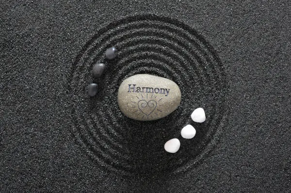Zen garden with yin and yang stones and harmony in textured sand